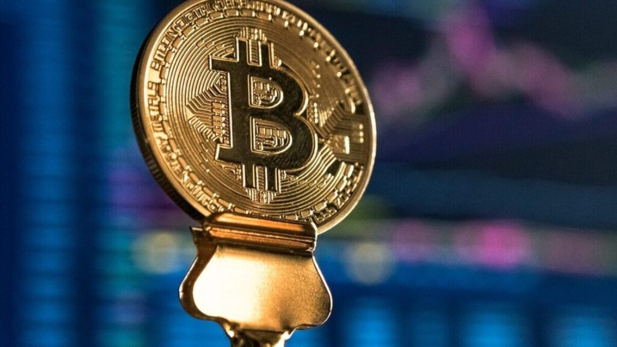 selective focus photo of Bitcoin near monitor