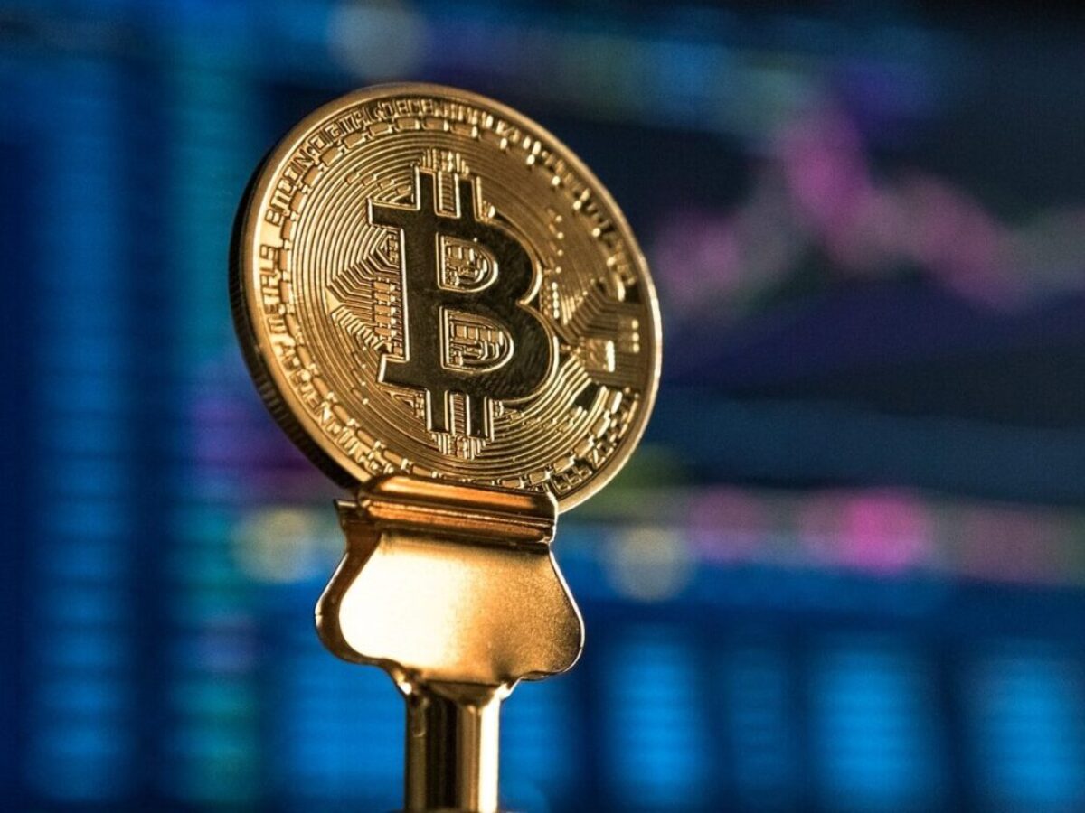 selective focus photo of Bitcoin near monitor