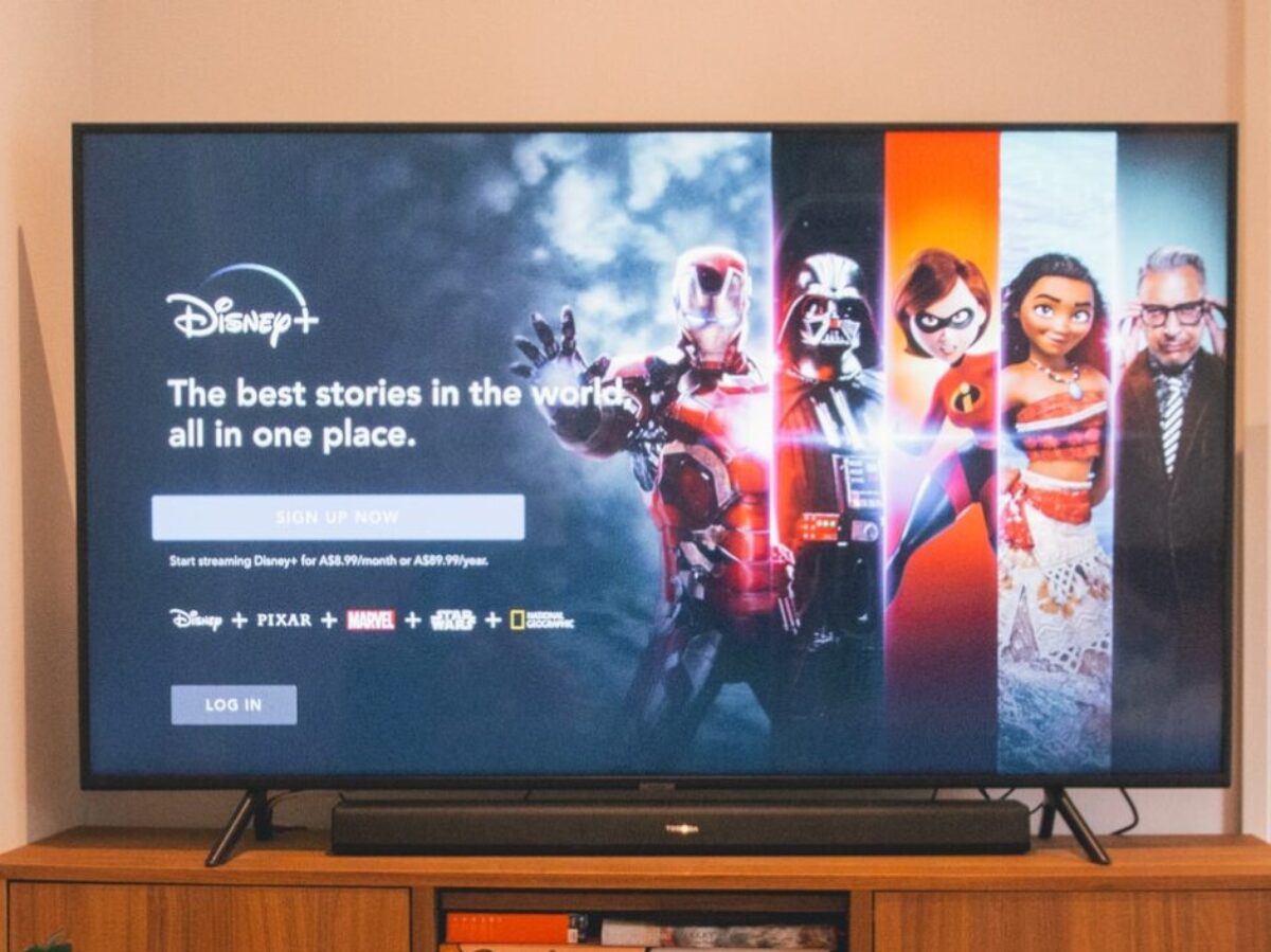 black flat screen tv turned on on brown wooden tv rack