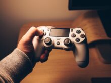 person holding black sony ps 4 controller