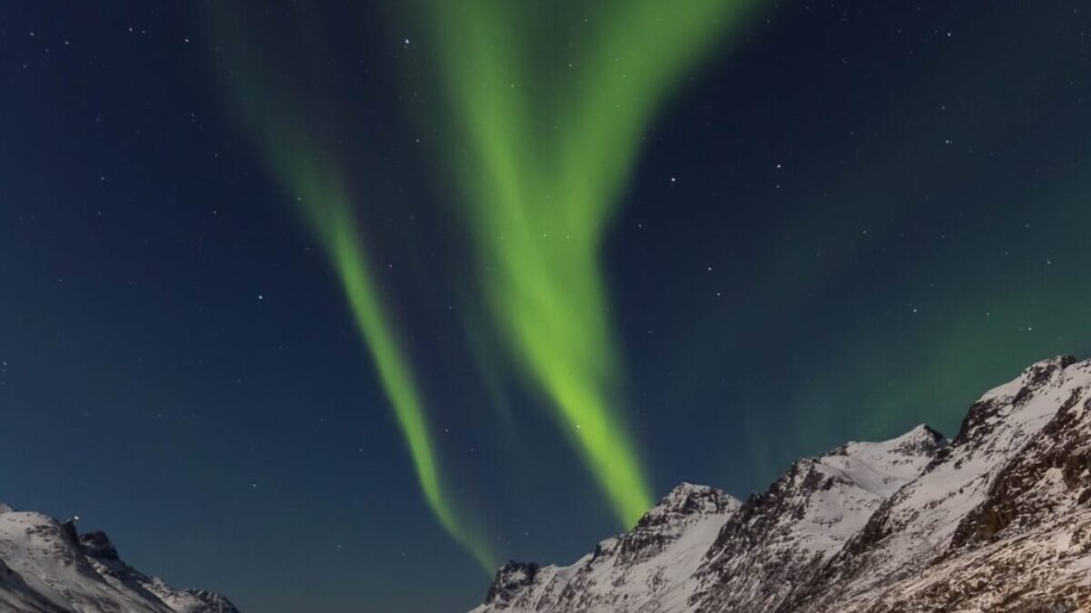 brown mountain hills at green sky during nighttime