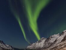 brown mountain hills at green sky during nighttime
