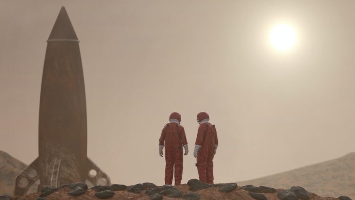 3 men standing on rocky shore during daytime