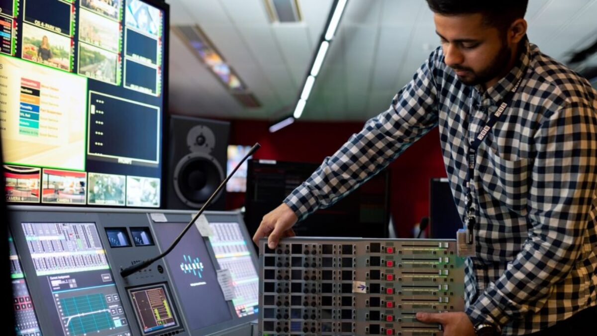 man in black and white checkered dress shirt playing dj controller