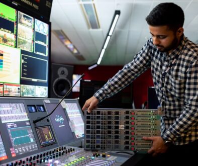 man in black and white checkered dress shirt playing dj controller