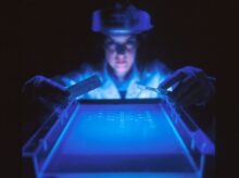 woman doing research while holding equipment