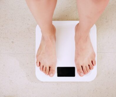 person standing on white digital bathroom scale