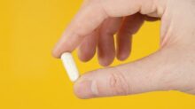person holding white cigarette stick