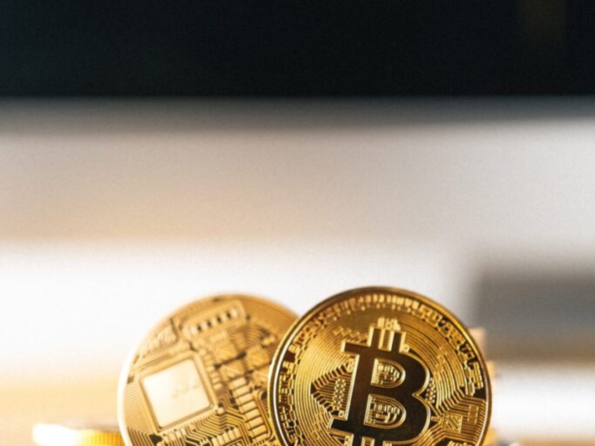 gold round coin on white surface