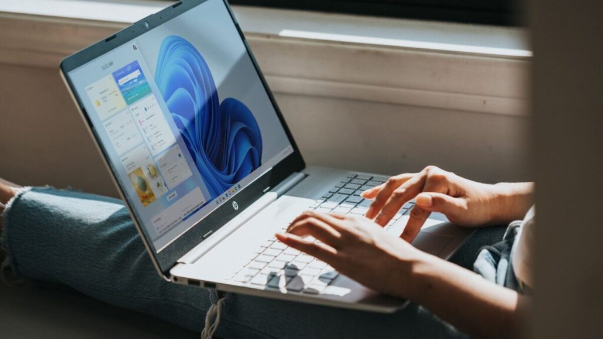 person using Windows 11 computer on lap