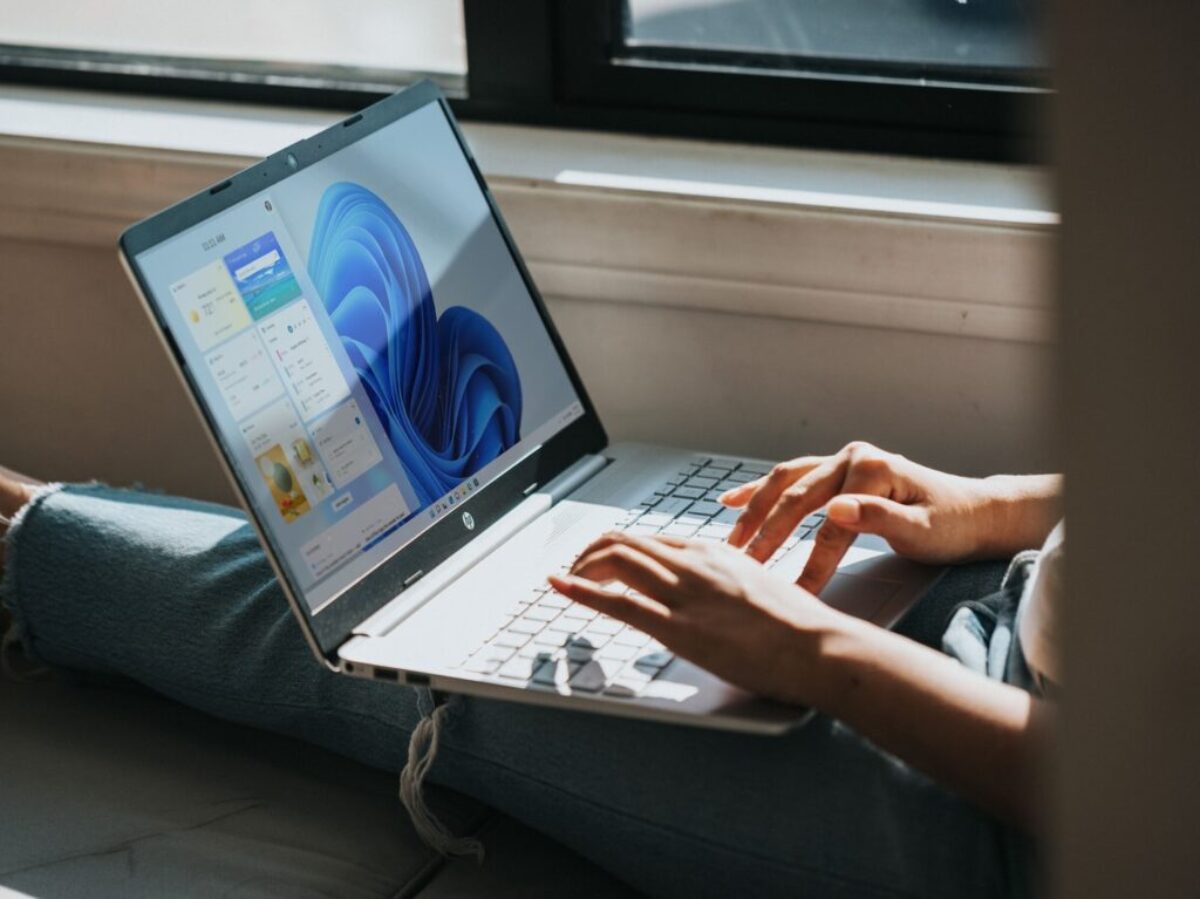 person using Windows 11 computer on lap