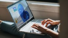 person using Windows 11 computer on lap
