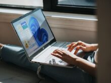 person using Windows 11 computer on lap