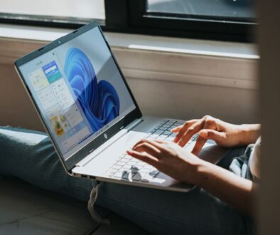 person using Windows 11 computer on lap