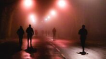 silhouette of people walking on street during night time