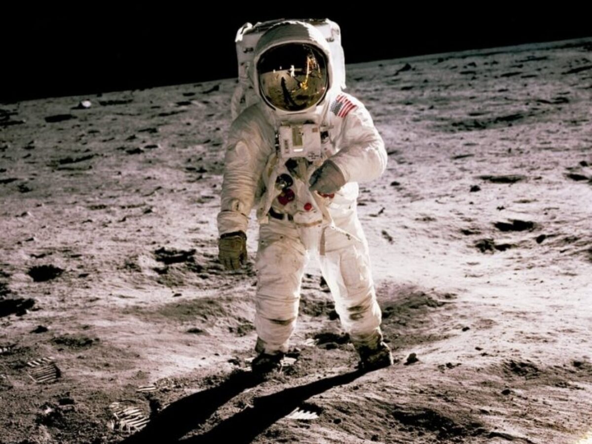 astronaut standing on gray sand