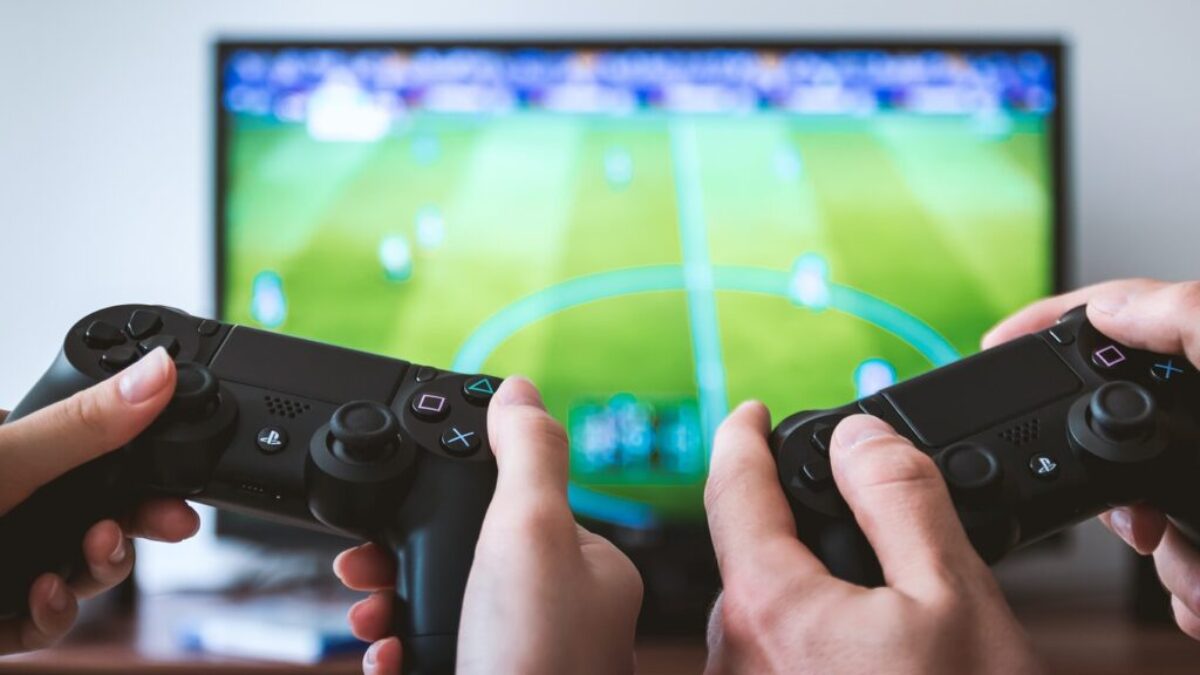 two people playing Sony PS4 game console