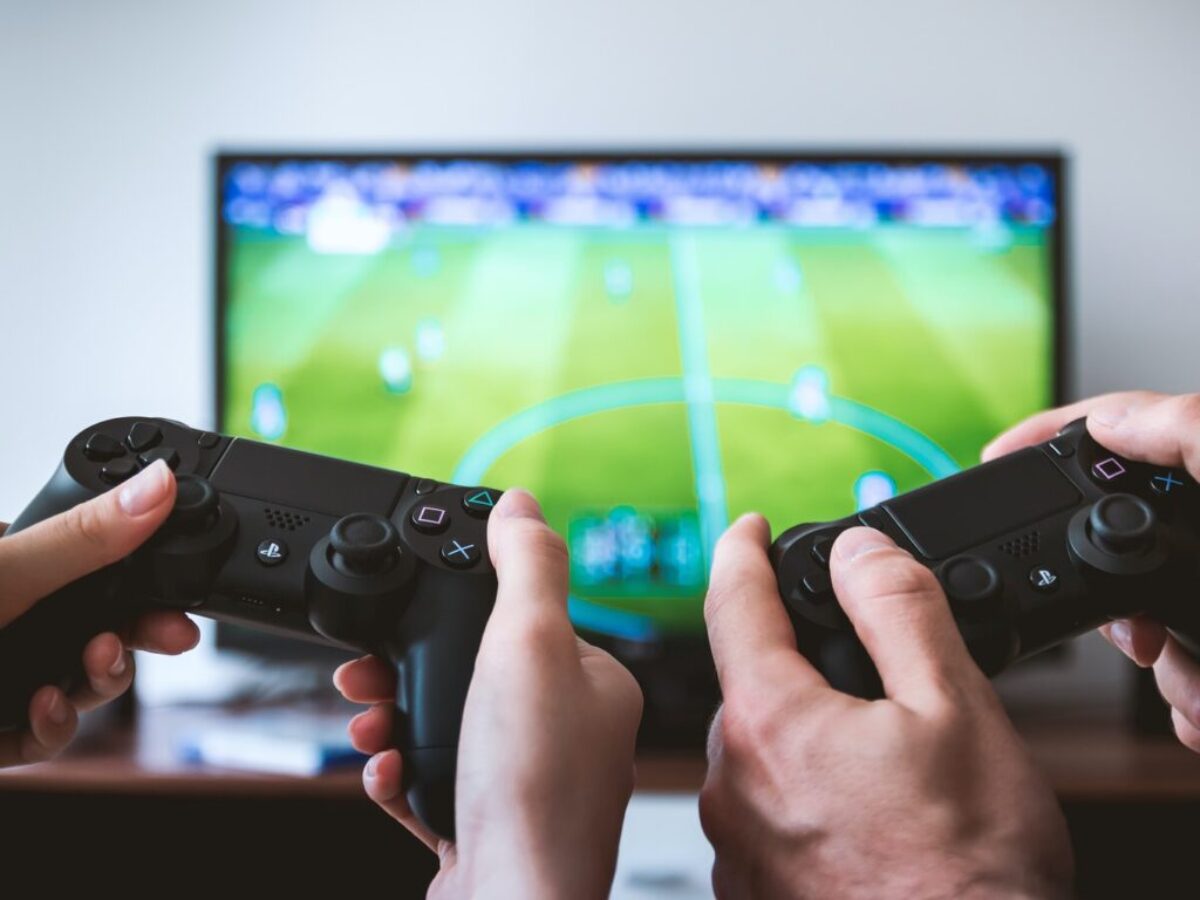 two people playing Sony PS4 game console
