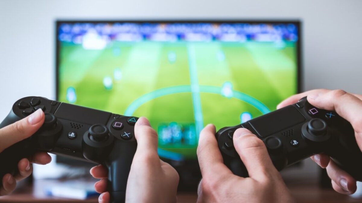 two people playing Sony PS4 game console