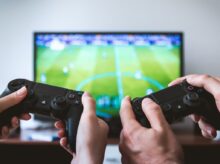 two people playing Sony PS4 game console