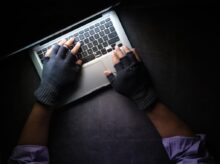 person in black long sleeve shirt using macbook pro