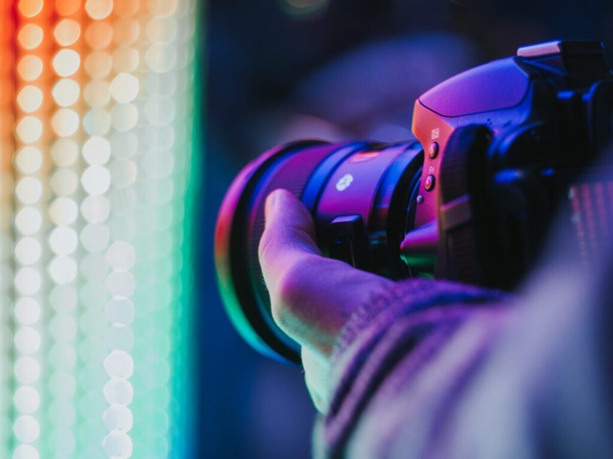 person holding DSLR camera