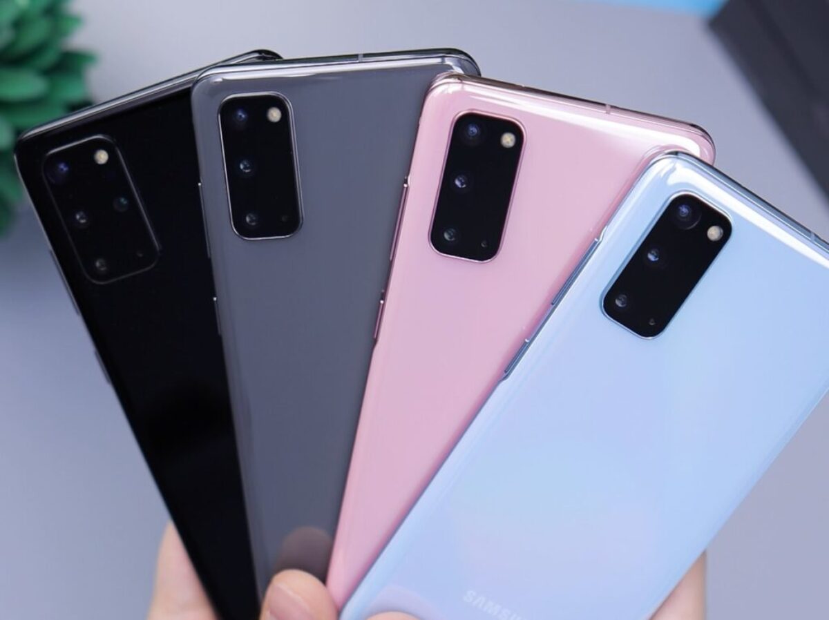 person holding pink and black iphone case