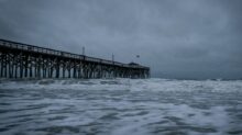 brown wooden dock on sea under white clouds