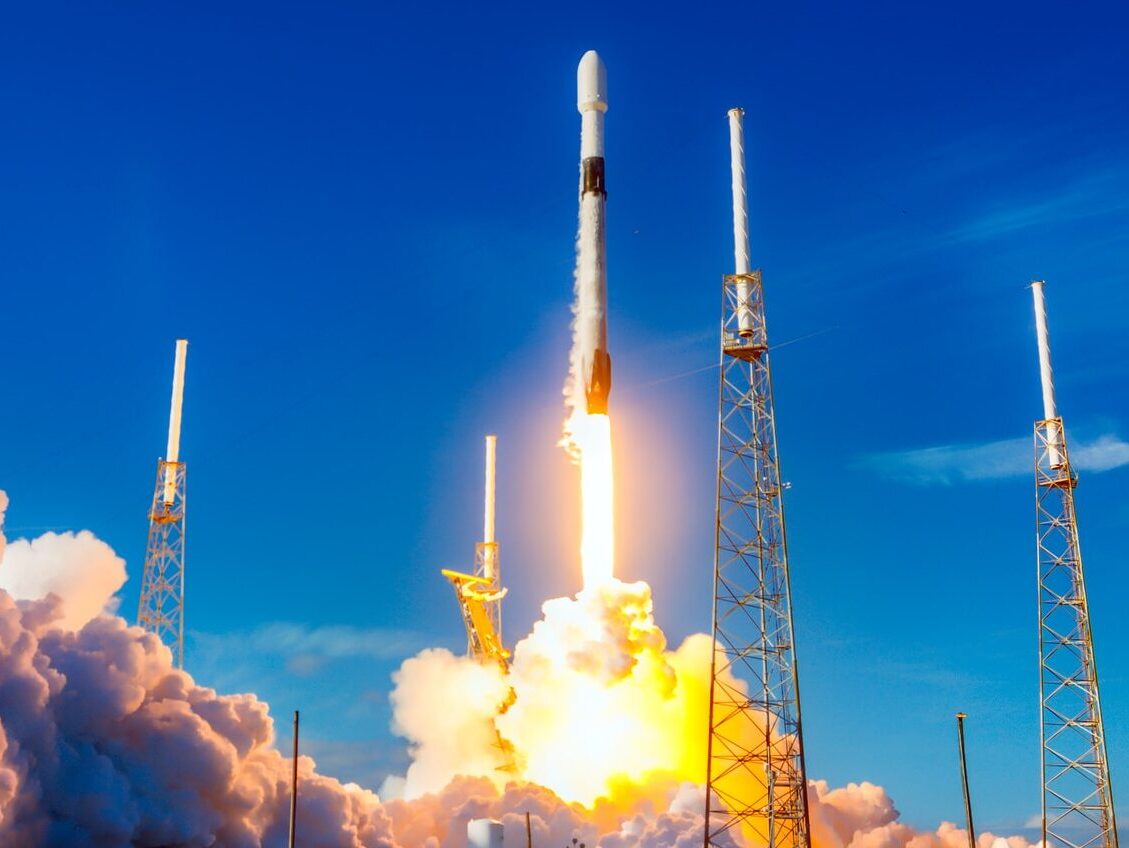 white and red space ship on blue sky during daytime