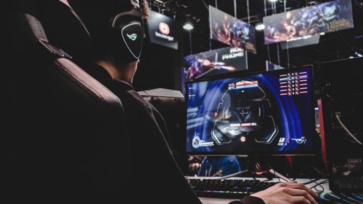 person sitting on gaming chair while playing video game