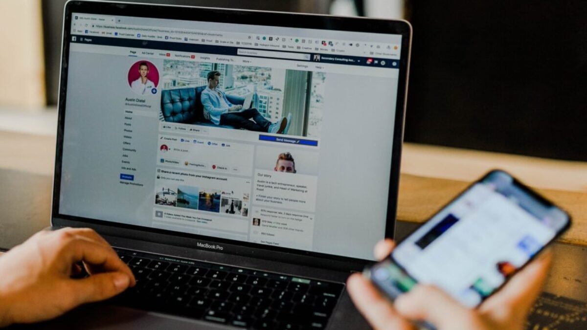 person using both laptop and smartphone