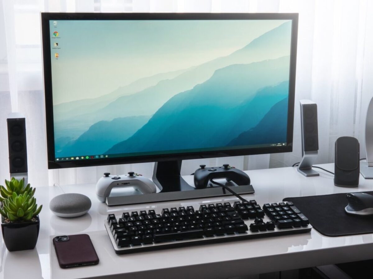 black computer keyboard beside silver imac