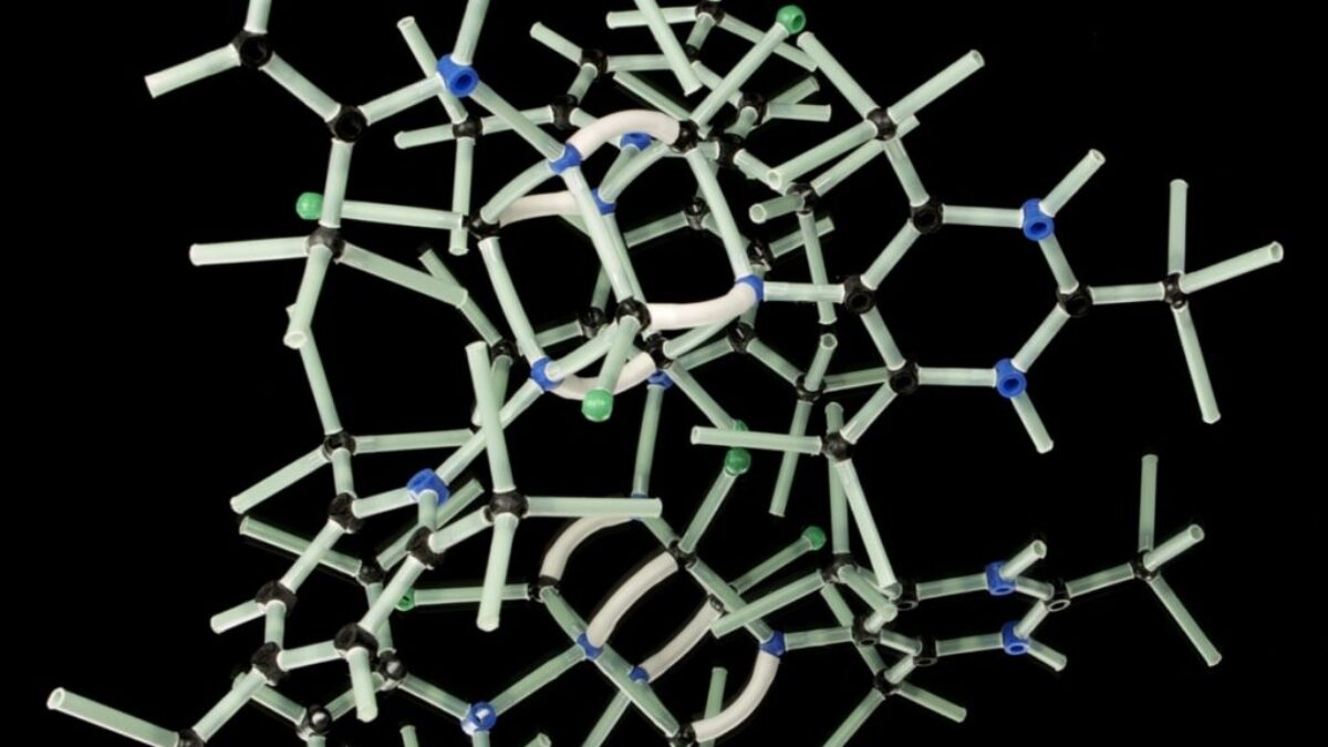 white plastic wire puzzle with black background