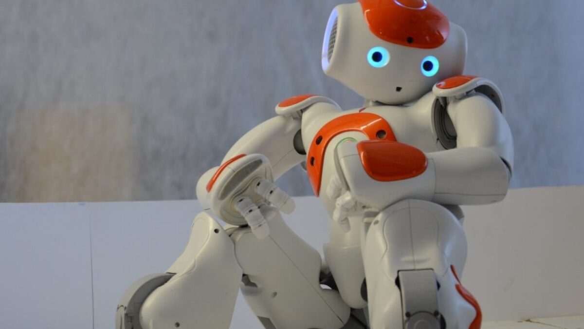 white and orange robot near wall