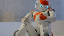 white and orange robot near wall