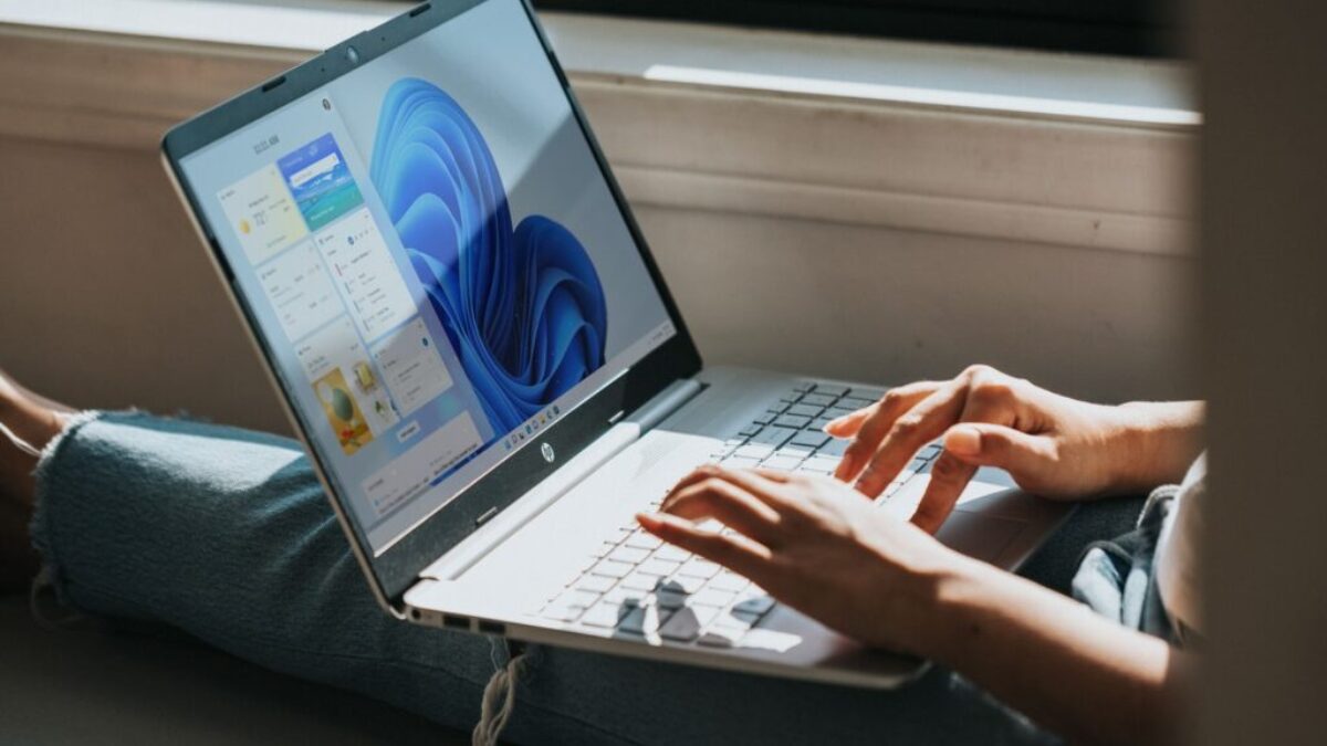 person using Windows 11 computer on lap