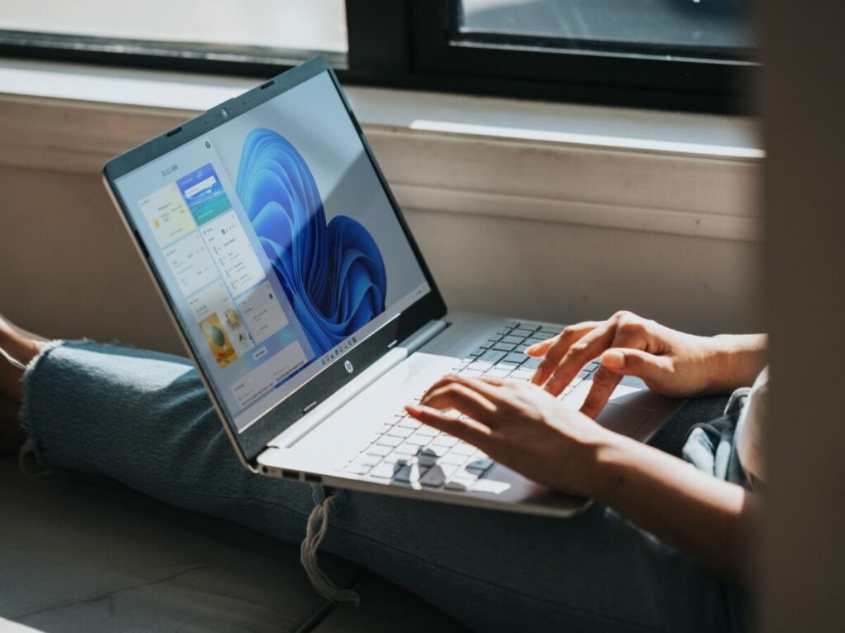 person using Windows 11 computer on lap