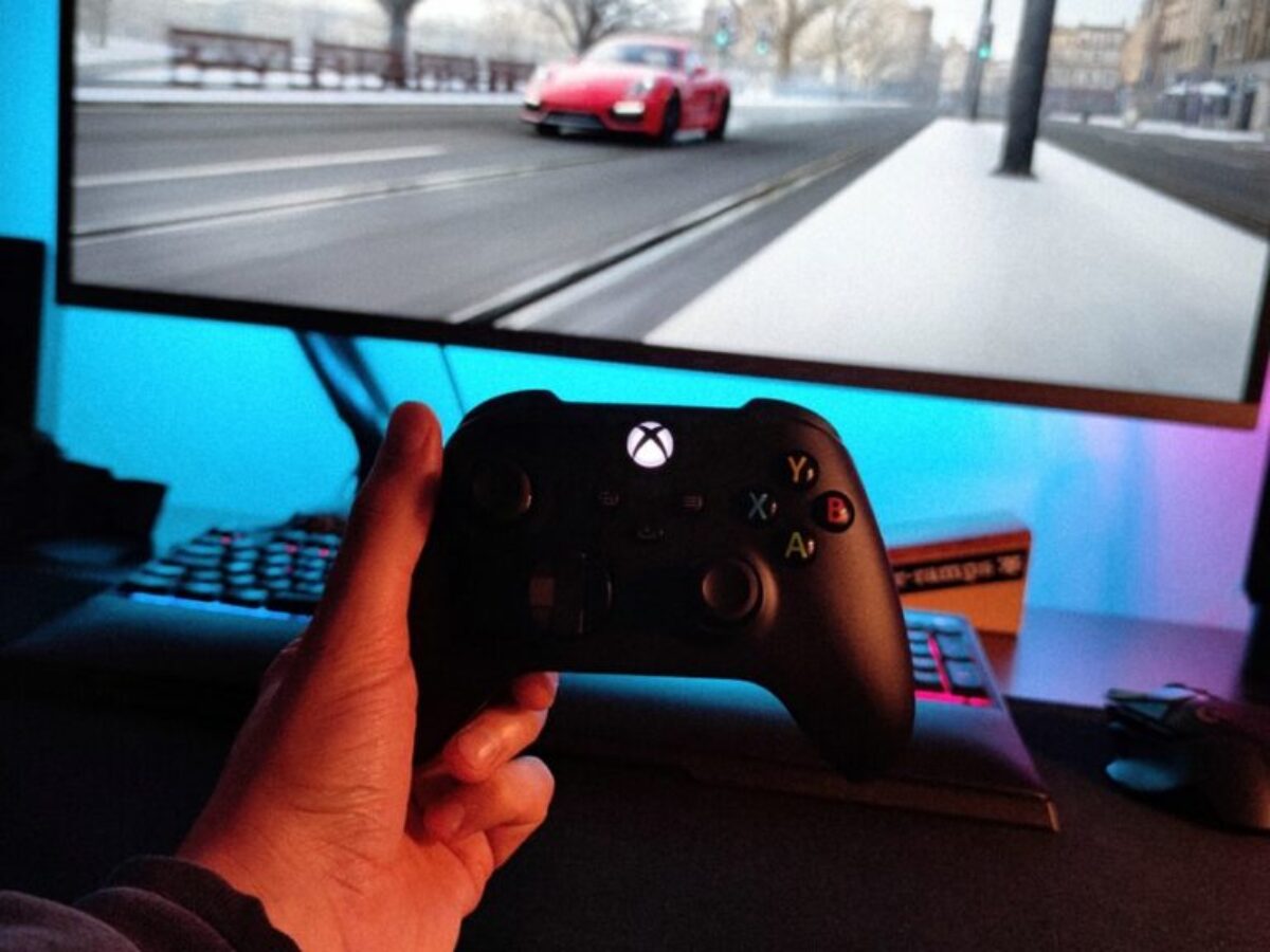 person holding black xbox one game controller
