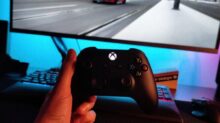 person holding black xbox one game controller