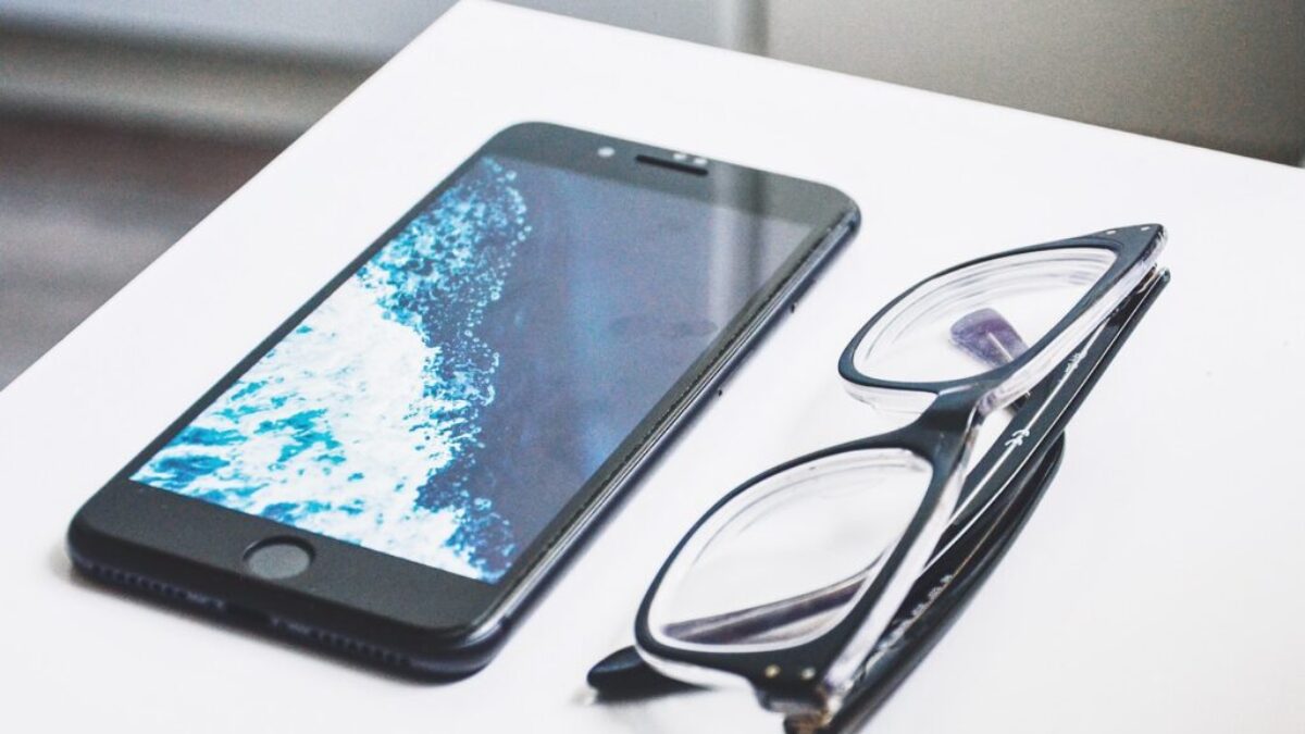black eyeglasses near iPhone