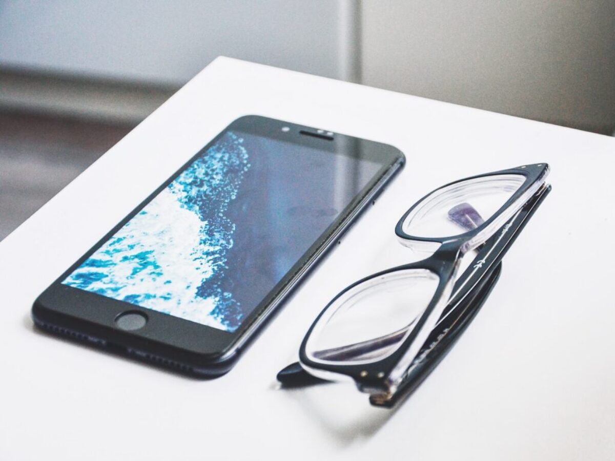 black eyeglasses near iPhone