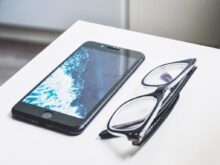 black eyeglasses near iPhone
