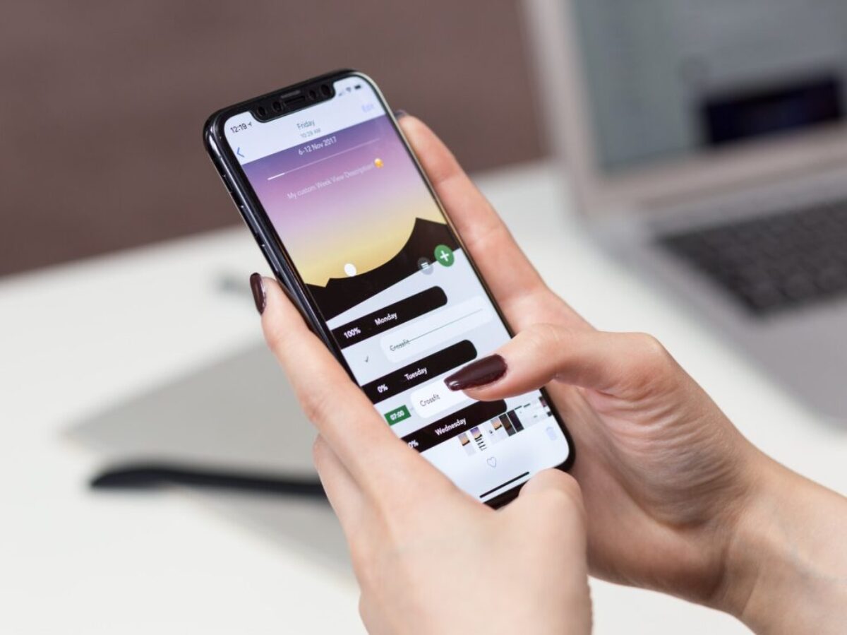person hand holding iPhone X