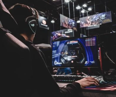 person sitting on gaming chair while playing video game