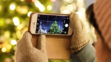 person taking photo of Christmas tree