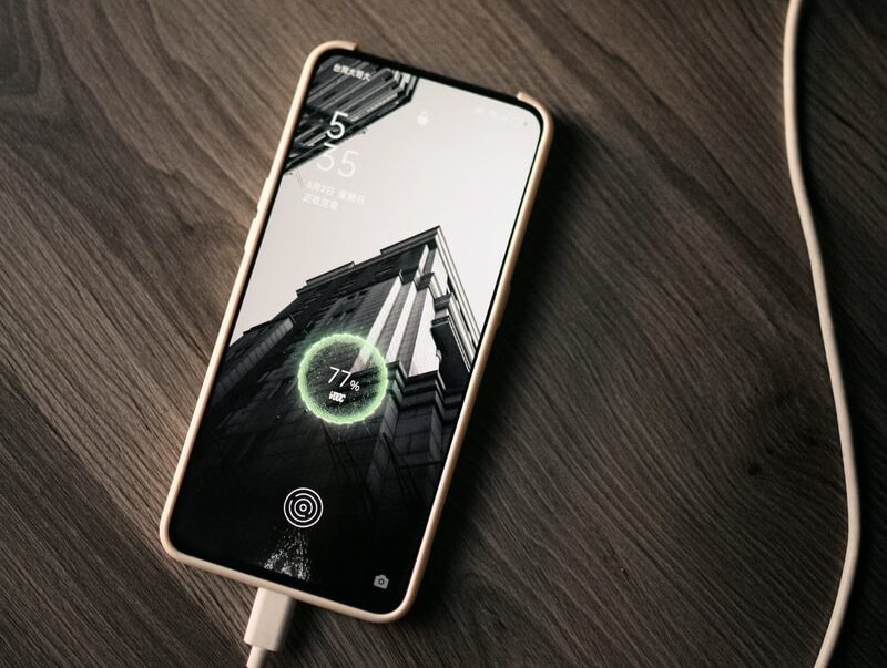 white iphone 5 c on brown wooden table