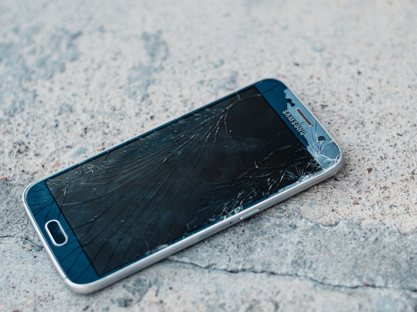 blue samsung android smartphone on gray marble table