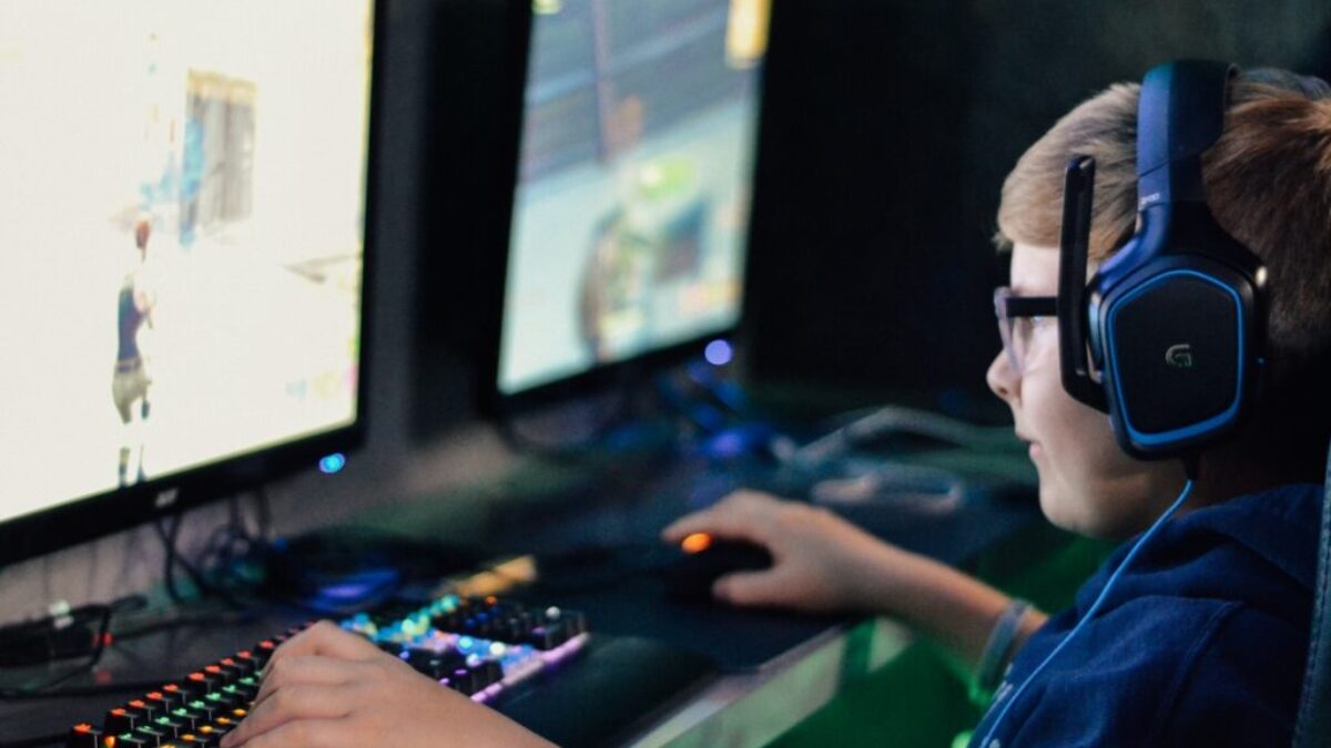 boy wearing headset playing computer game