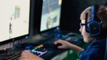 boy wearing headset playing computer game