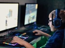 boy wearing headset playing computer game